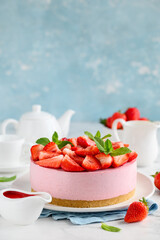 Strawberry no bake cheesecake decorated with fresh berries and mint. Summer dessert. Selective focus. Copy space