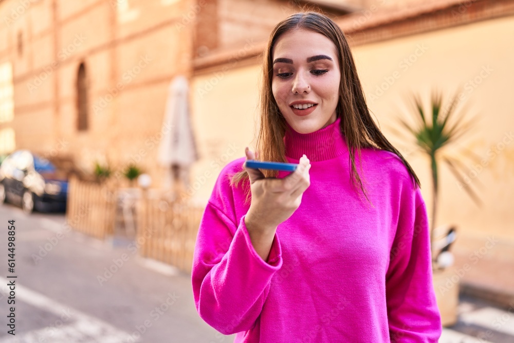 Poster Young woman smiling confident talking on the smartphone at street