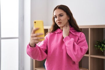 Young woman having telemedicine at home