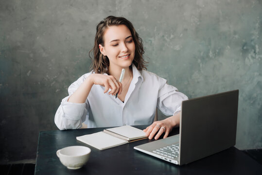 Empowering Distance Learning: Woman Engaged in E-Learning with Laptop at Home. Student's Productive Environment for Work or Study from Home, Business, Creativity, and Online Meetings.