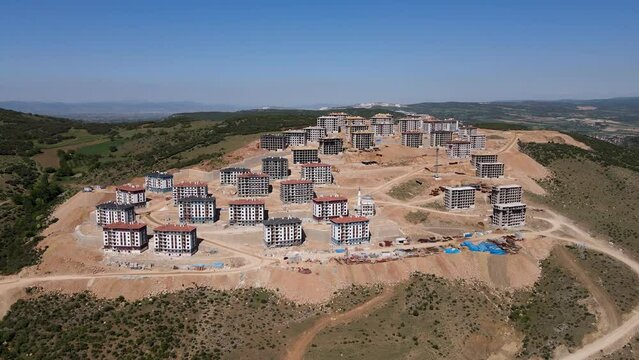 Aerial view of the mass housing construction site on the mountain slope.