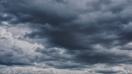 Fototapeta premium Overcast sky with dark clouds. Dark sky before a thunder-storm. The gray cloud background before rain.
