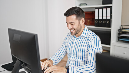Young hispanic man business worker using computer working at office