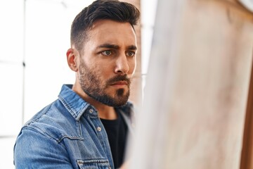 Young hispanic man drawing at art studio