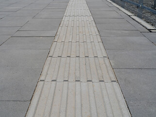Fototapeta premium Tactile Paving on Modern Tiles Pathway for Blind Handicap, Safety Sidewalk Walkway for Disability People
