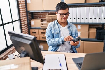 Down syndrome man ecommerce business worker using data phone at office