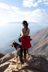 Girl with dog in mountains