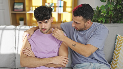 Two men couple hugging each other looking upset supporting at home