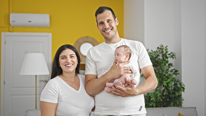 Family of three bonding standing at home