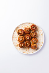 Grilled champignon mushrooms. On a white background.