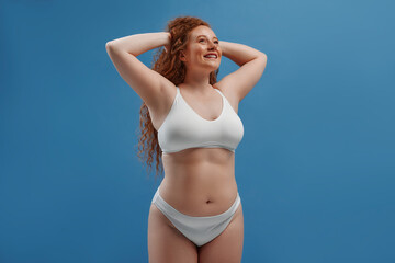 Redhead girl with freckles on a blue background