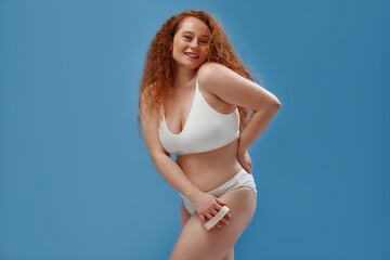 Redhead girl with freckles on a blue background