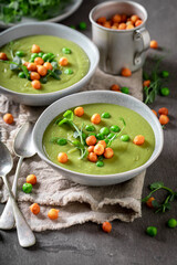Homemade pea soup with peas puff and sprouts.