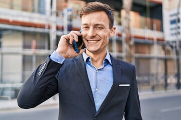 Young man business worker smiling confident talking on smartphone at street