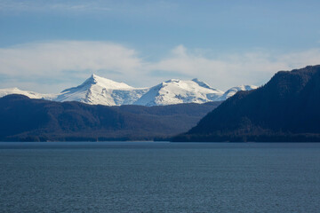 scenic landscape photograph of the snowcapped mountains of Alaska from the ocean view.