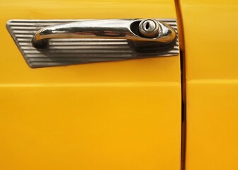 Yellow classic Car Door handle close up 