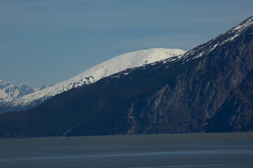 scenic landscape photograph of the snowcapped mountains of Alaska from the ocean view.