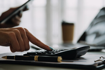 Young adult happy smiling Hispanic Asian student wearing headphones talking on online chat meeting using laptop in university campus or at virtual office. College female student learning remotely.