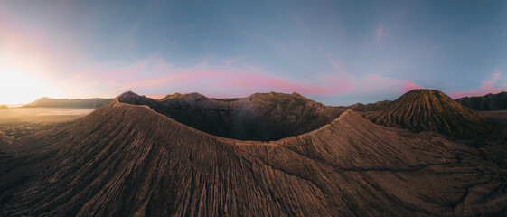 Aerial drone view of Bromo crater Mountain, East Java, Indonesia. man standing on the edge of Bromo...