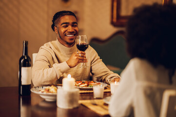 Smiling african american man having a romantic date with his girlfriend at home