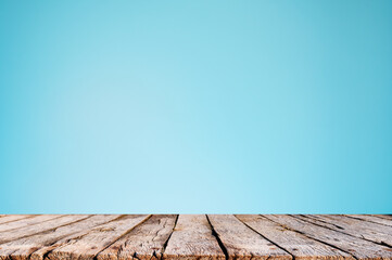 Empty old wooden table top on blue background