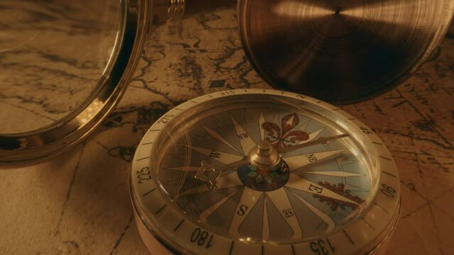 Compass and magnifier on a old vintage world map with countries and continents. Retro style. Concept of geography or global history and cartography. Wars of conquest and navigation. 4K ProRes
