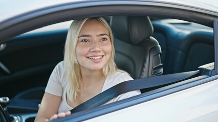 Young beautiful hispanic woman smiling confident sitting on car at street