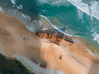 High angle aerial bird's eye drone view of the Maheno shipwreck on Seventy-Five Mile Beach on...