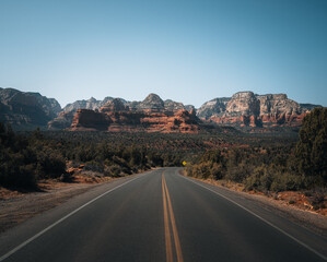Fototapeta na wymiar Highway view towards mountains of Sedona, Arizona. Bell Rock and Cathedral mountain is a butte just north of Village of Oak Creek, Arizona, south of Sedona in Yavapai County.USA.