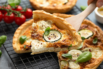 Sun baked tomato, goats cheese and courgette quiche served in cast iron pan with side salad