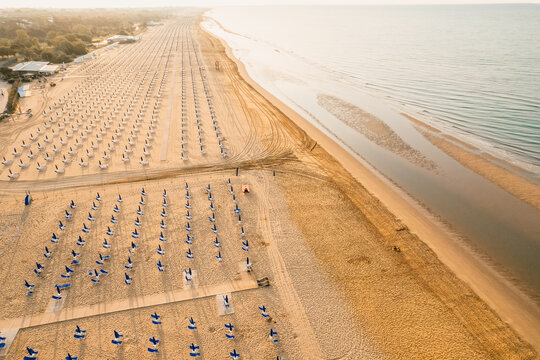 Morning on the still deserted beach. Umbrella beach for relaxing and sun set beach. Bibione, Italy
