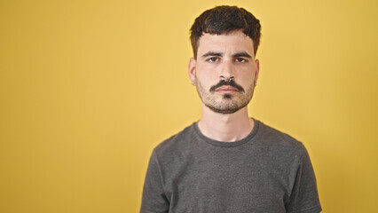 Fototapeta premium Young hispanic man standing with relaxed expression over isolated yellow background