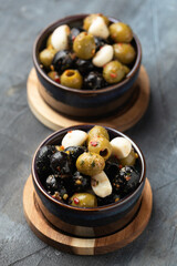Marinated olives with herbs and garlic in bowl