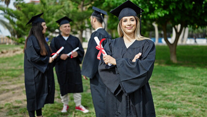 Group of people students graduated holding diploma standing with arms crossed gesture at university...