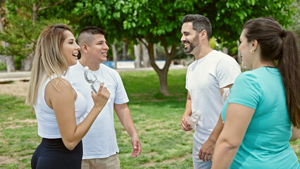 Group of people wearing sportswear speaking at park