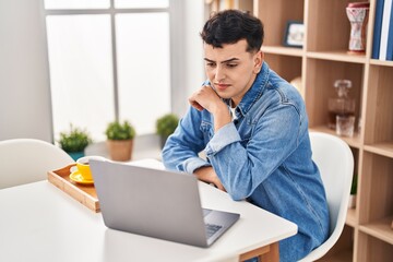 Young non binary man having video call and breakfast at home
