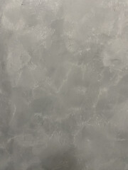 Textured plaster, gray wall.