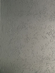 Textured plaster, gray wall.