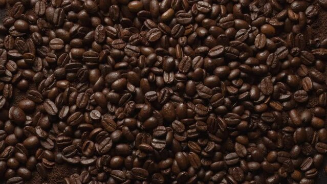 Close up of seeds of coffee top view. Fragrant coffee beans are roasted smoke. 4K ProRes