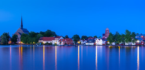 Blue hour panoramic view of Vadstena townscape at the lake of Vattern with the famous Abbey of Our Lady and Holy Bridget