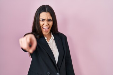 Young brunette woman wearing business style over pink background pointing displeased and frustrated to the camera, angry and furious with you