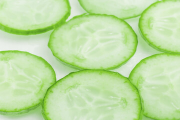 Thinly sliced slices of fresh green cucumber.