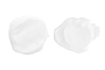 A set of different strokes of white cream on a white background.