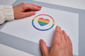 Rainbow heart on a light paper background. LGBT flag. LGBTQIA Pride Month in June. Lesbian gay...