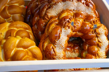 Yeast round closed cake on a wooden table . Muffin - ruddy, delicious pastries. Kalach - round bread.