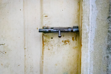 old latch lock on rustic wall