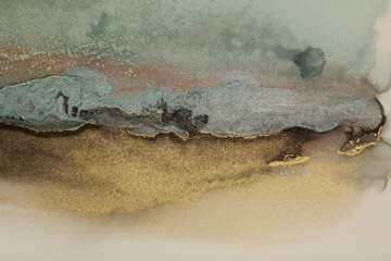 Watercolor and alcohol ink smoke flow stain blot on paper background. Beige, brown, blue and gold...