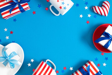Obraz premium 4th of July, USA Presidents Day, Independence Day, US election concept. Gift striped box with bow, cup in stars, plate, star confetti on blue background. Flat lay, top view, copy space