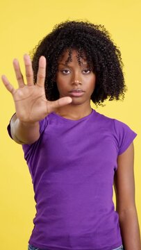 Serious woman with African hair gesturing rejection