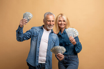 Wealthy rich happy elderly man and woman with cash money